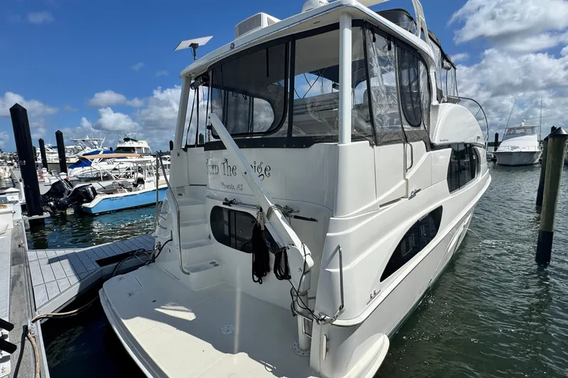 Slide: The Image of 2003 Silverton 43 Motor Yacht docked at marina under blue sky. - 7