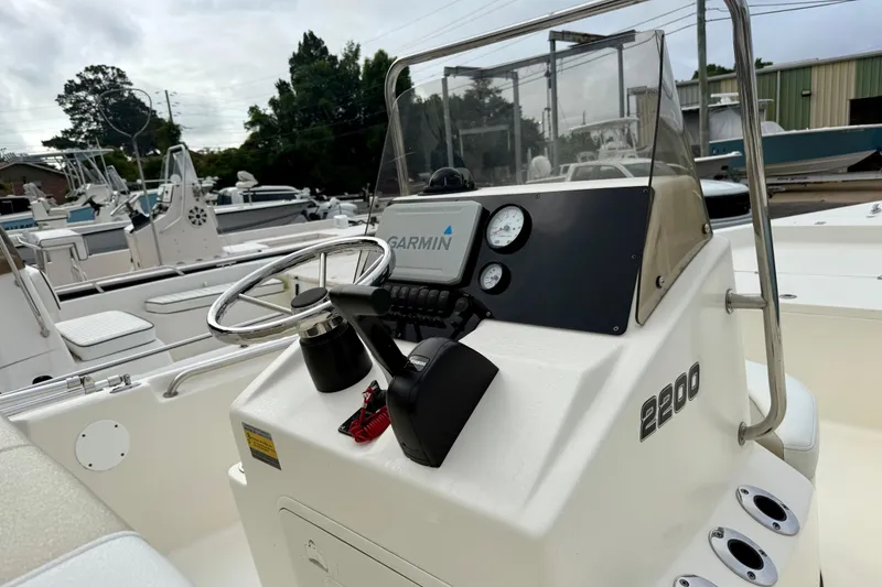 Slide: The Image of 2021 Bulls Bay 2200 boat console with Garmin navigation system and steering wheel. - 1