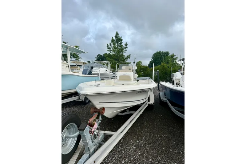 Slide: The Image of 2021 Bulls Bay 2200 boat on trailer, parked outdoors under cloudy sky. - 4