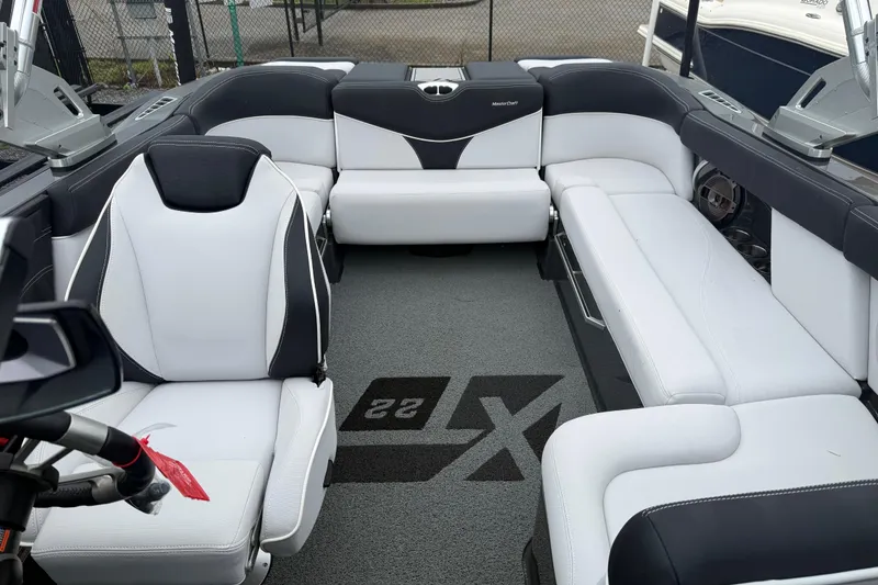 Slide: The Image of Interior of a 2021 MasterCraft XT22 boat with sleek white and black seating. - 10