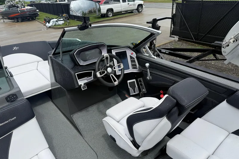 Slide: The Image of 2021 MasterCraft XT22 boat interior with steering wheel and seating. - 19