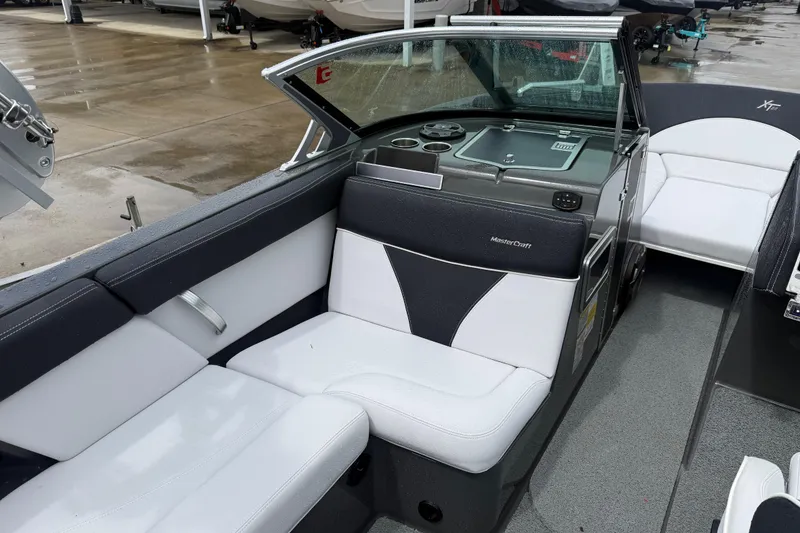 Slide: The Image of 2021 MasterCraft XT22 boat interior with sleek white and black seating. - 20