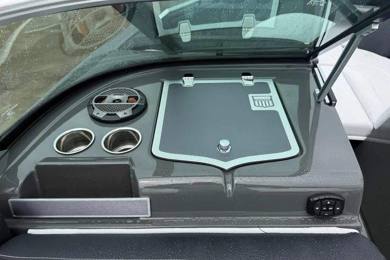 Slide: The Image of 2021 MasterCraft XT22 boat dashboard with cup holders and speaker, featuring sleek design elements. - 21