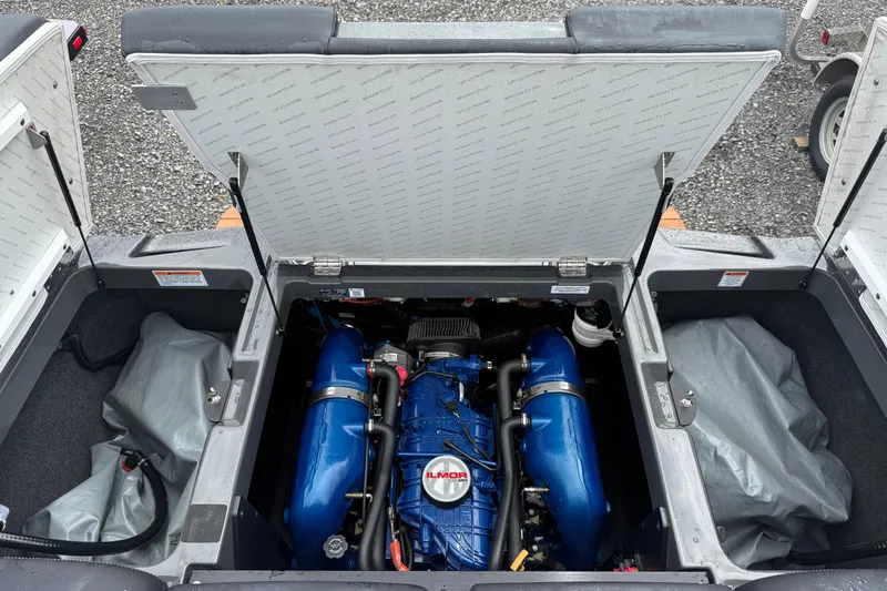 Slide: The Image of 2021 MasterCraft XT22 boat engine compartment with blue Ilmor engine. - 26