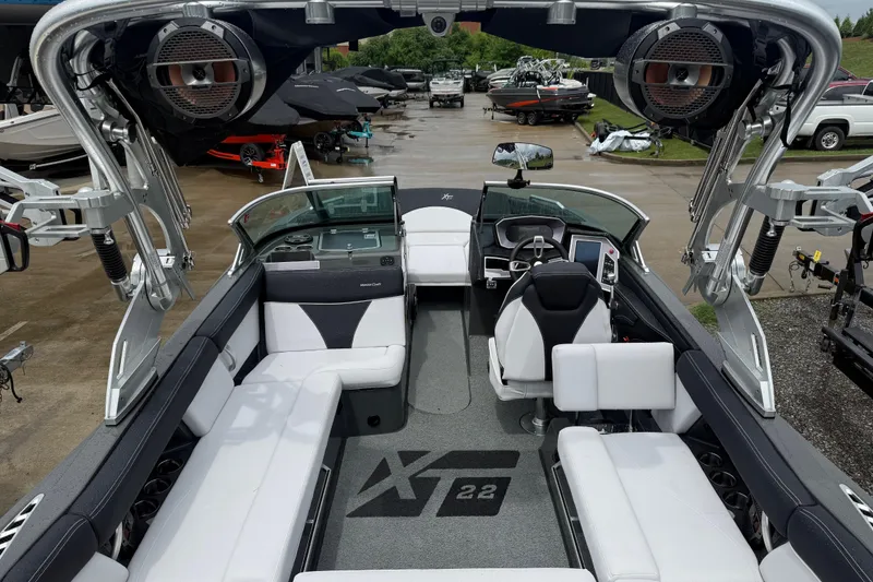 Slide: The Image of 2021 MasterCraft XT22 boat interior with sleek seating and advanced controls. - 30