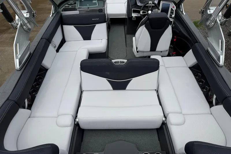 Slide: The Image of 2021 MasterCraft XT22 boat interior with luxurious seating and modern dashboard. - 31