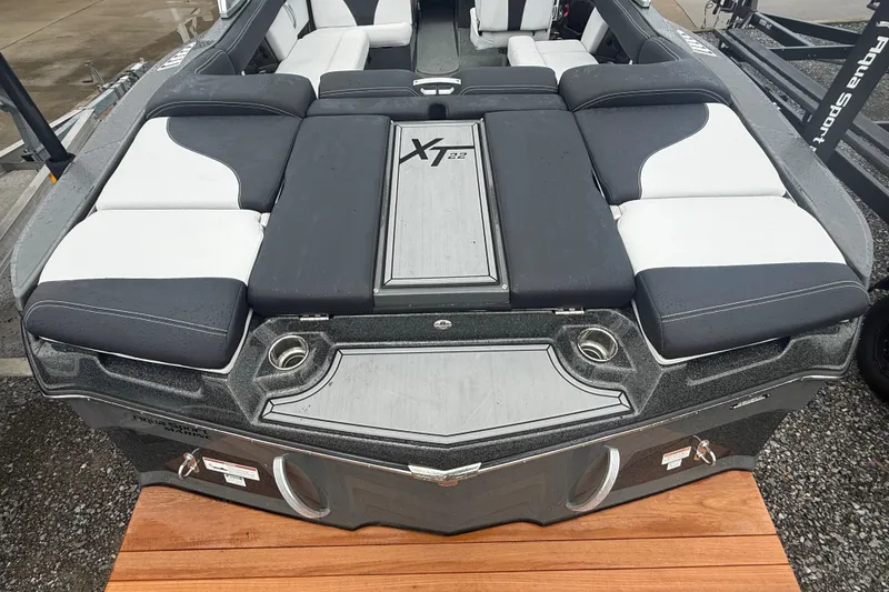 Slide: The Image of 2021 MasterCraft XT22 boat interior with cushioned seating and sleek design. - 34