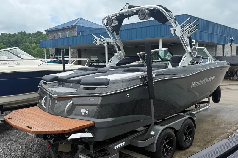Slide: The Image of 2021 MasterCraft XT22 boat on trailer, parked outside dealership. - 4