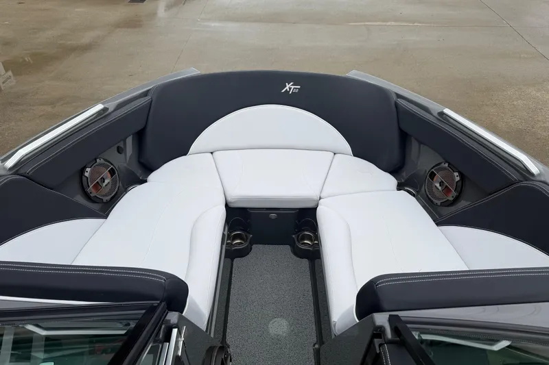 Slide: The Image of 2021 MasterCraft XT22 boat interior with white and black seating, featuring built-in speakers. - 7