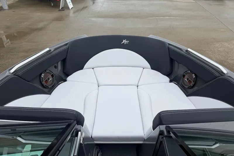 Slide: The Image of 2021 MasterCraft XT22 boat interior with white cushioned seating and built-in speakers. - 8