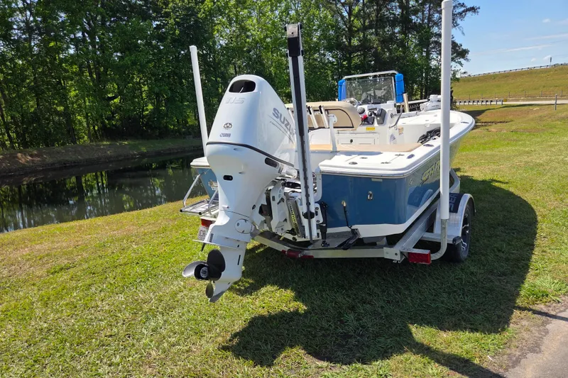 Slide: The Image of 2024 Sea Pro 172 Bay boat on trailer near a scenic waterway. - 3