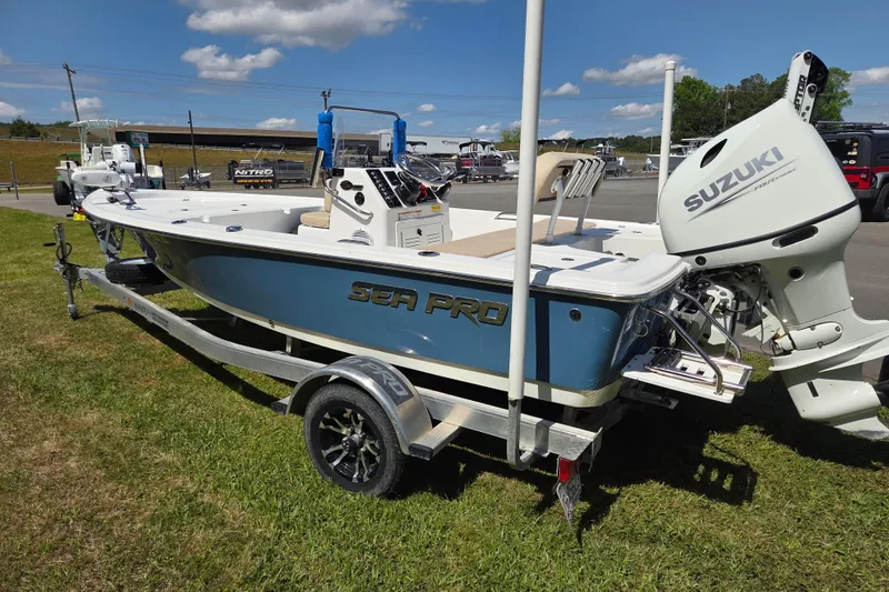 Slide: The Image of 2024 Sea Pro 172 Bay boat with Suzuki engine on trailer, parked outdoors. - 5