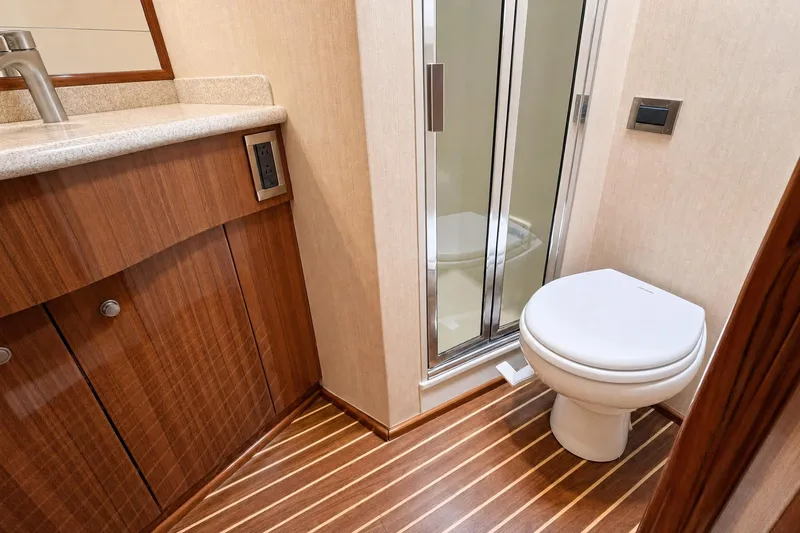 Slide: The Image of Luxurious bathroom in 2008 Viking 52 Sport Coupe yacht with wood accents and modern fixtures. - 15