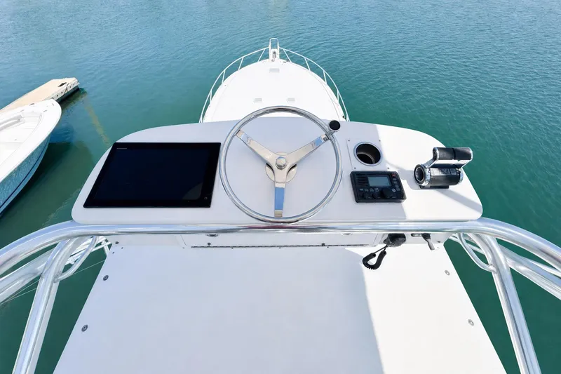 Slide: The Image of Helm of 2008 Viking 52 Sport Coupe yacht with steering wheel and navigation equipment. - 19