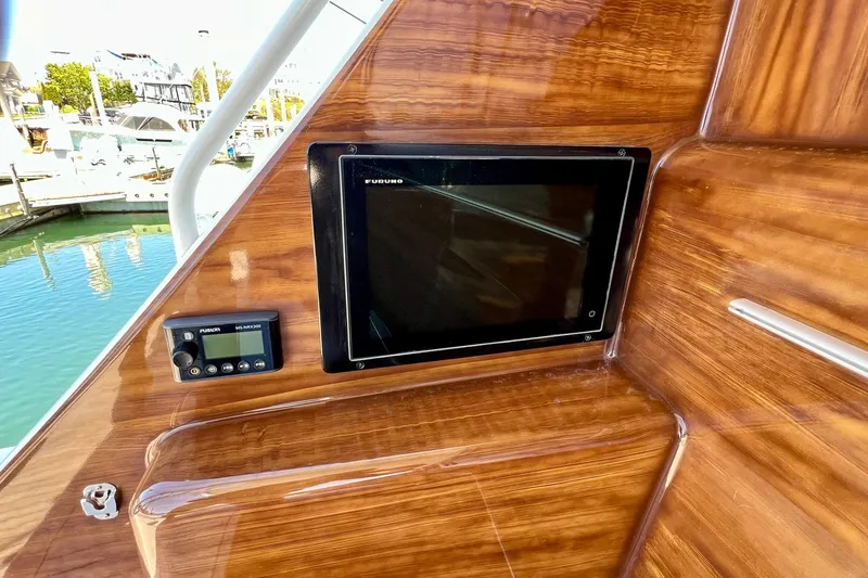 Slide: The Image of Control panel on 2008 Viking 52 Sport Coupe yacht with wood finish and navigation display. - 23
