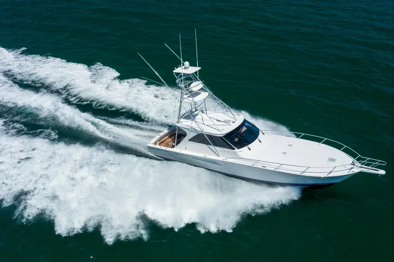 Slide: The Image of 2008 Viking 52 Sport Coupe cruising swiftly on open water. - 5