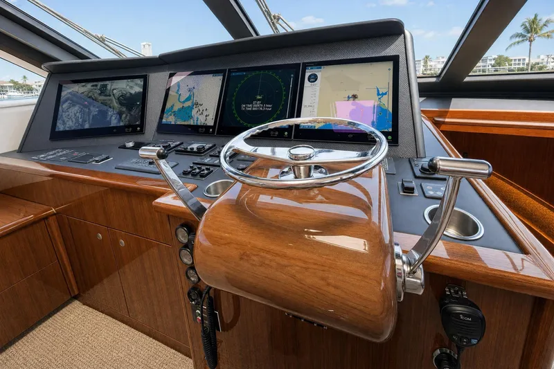 Slide: The Image of Helm of 2008 Viking 52 Sport Coupe with navigation screens and wooden steering wheel. - 6