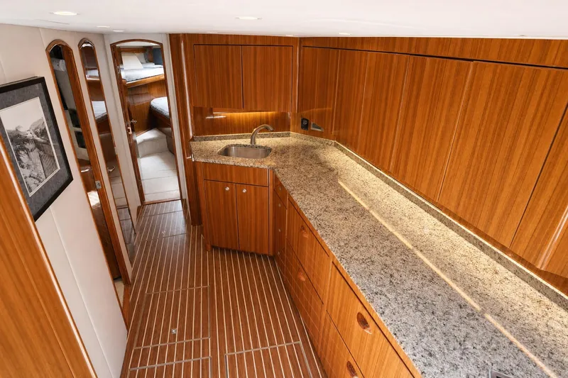Slide: The Image of Luxurious interior of 2008 Viking 52 Sport Coupe yacht with wood cabinetry and granite countertops. - 9