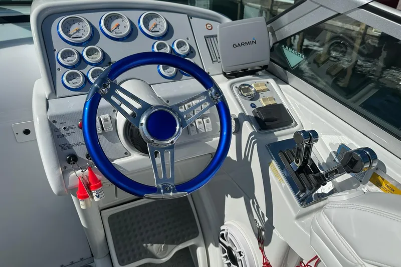 Slide: The Image of Cockpit of 2003 Formula 353 FASTech boat with blue steering wheel and Garmin navigation system. - 10