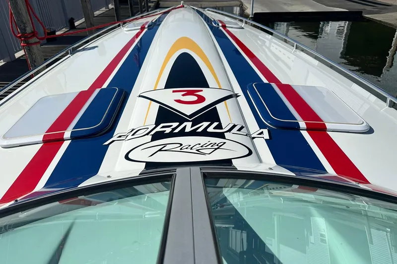 Slide: The Image of 2003 Formula 353 FASTech boat with racing stripes and logo on deck. - 12