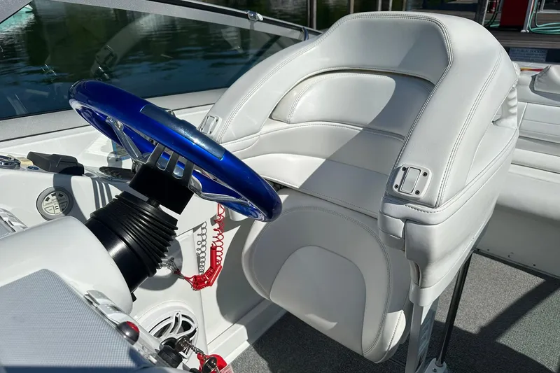 Slide: The Image of Interior of a 2003 Formula 353 FASTech boat with white seating and blue steering wheel. - 13