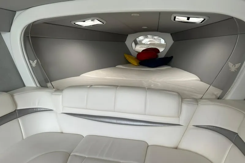 Slide: The Image of Interior of 2003 Formula 353 FASTech boat with white seating and colorful pillows. - 21