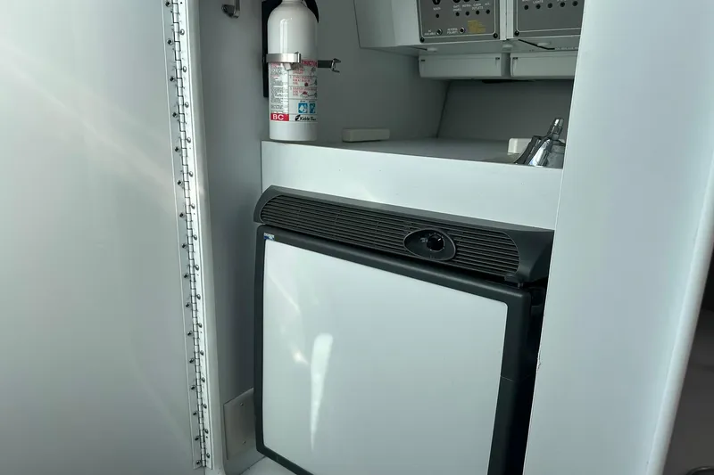 Slide: The Image of 2003 Formula 353 FASTech cabin interior with mini fridge and fire extinguisher. - 26