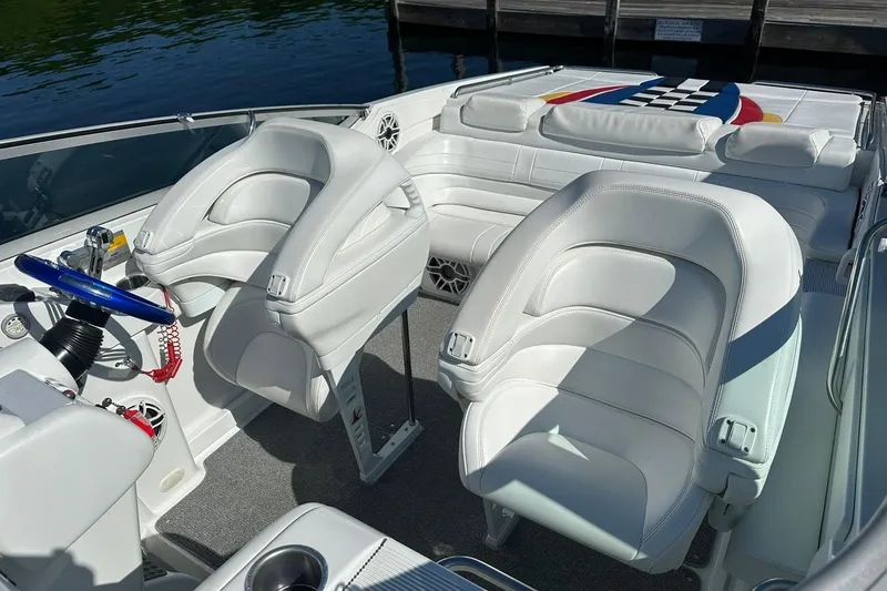 Slide: The Image of 2003 Formula 353 FASTech boat interior with white leather seats and blue steering wheel. - 4