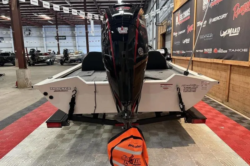 Slide: The Image of 2024 Tracker Pro Team 190 TX boat displayed indoors with motor and branding. - 3