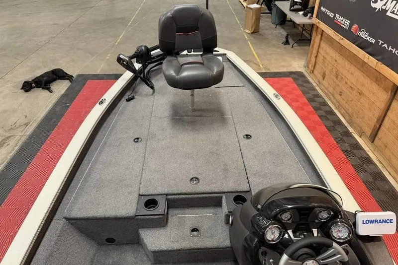 Slide: The Image of 2024 Tracker Pro Team 190 TX boat interior with steering console and seating. - 4