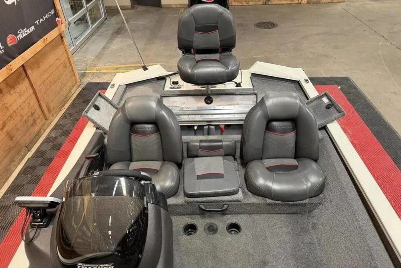 Slide: The Image of 2024 Tracker Pro Team 190 TX boat interior with gray seating and storage compartments. - 6