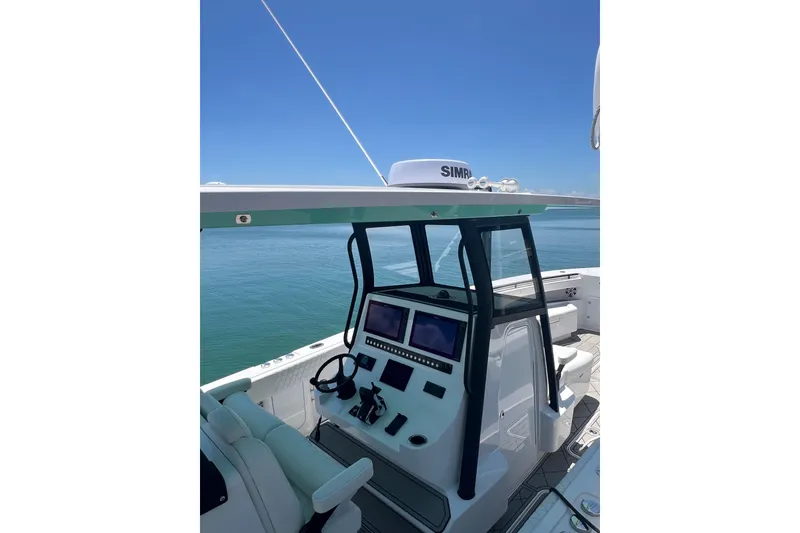 Slide: The Image of 2026 Reef Runner 340 boat helm with dual screens and ocean view. - 10