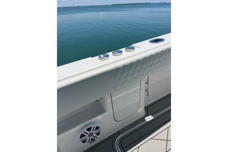 Slide: The Image of 2026 Reef Runner 340 boat deck with quilted upholstery and ocean view. - 15