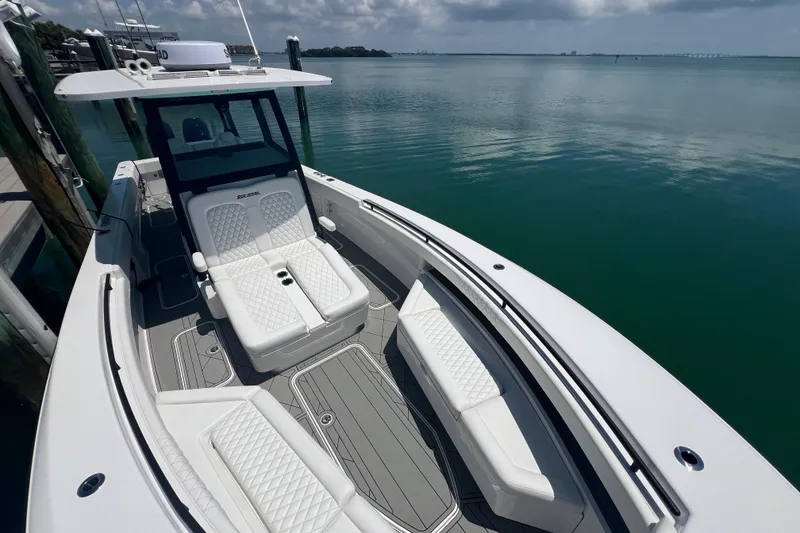 Slide: The Image of 2026 Reef Runner 340 boat with luxurious seating on calm water. - 18