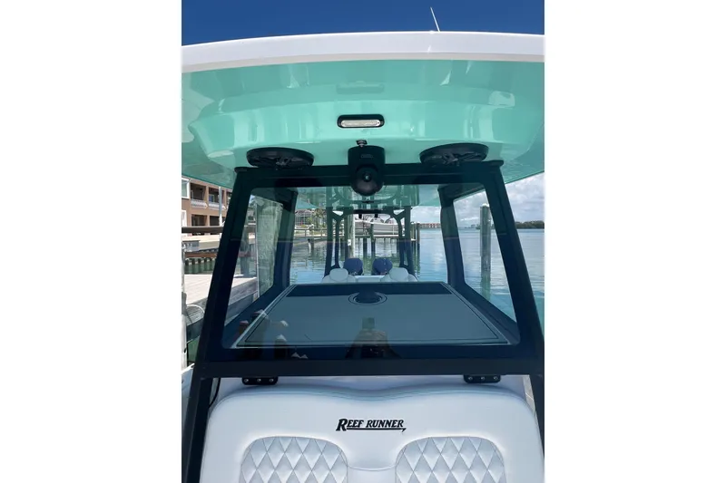 Slide: The Image of 2026 Reef Runner 340 boat docked, showcasing sleek design and modern features. - 4