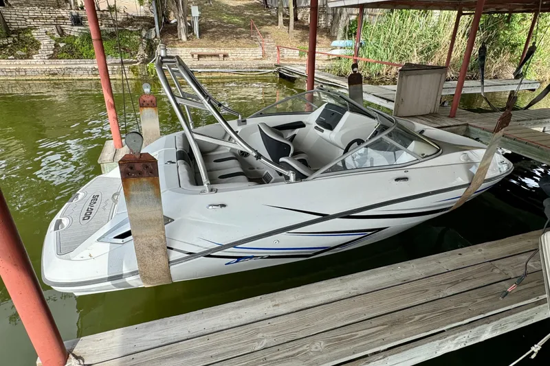 Slide: The Image of 2008 Sea-Doo 180 Challenger boat docked on a wooden pier. - 3