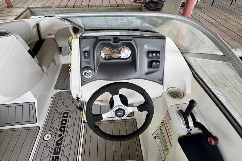 Slide: The Image of 2008 Sea-Doo 180 Challenger boat cockpit with steering wheel and control panel. - 9