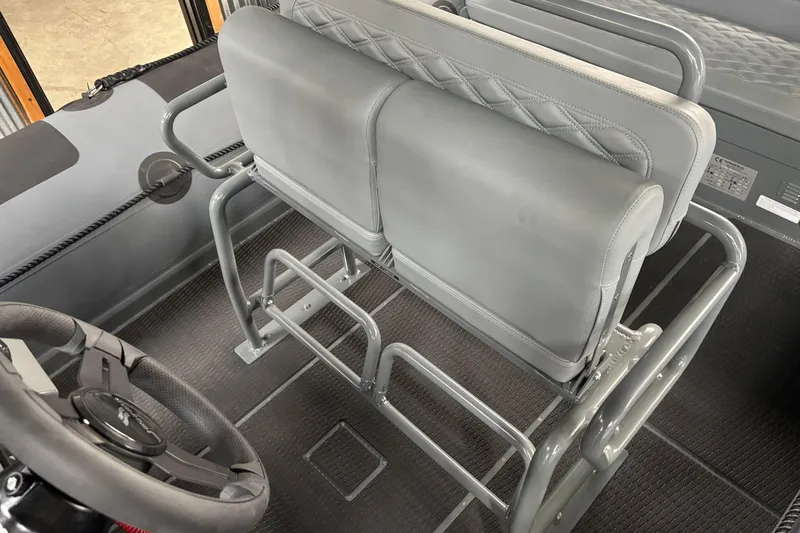 Slide: The Image of Interior view of 2026 Highfield Patrol 760 boat, featuring sleek gray seating and steering wheel. - 10