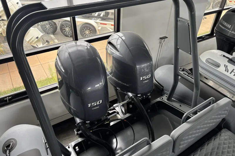 Slide: The Image of 2026 Highfield Patrol 760 boat with dual Yamaha 150 engines, interior view. - 12