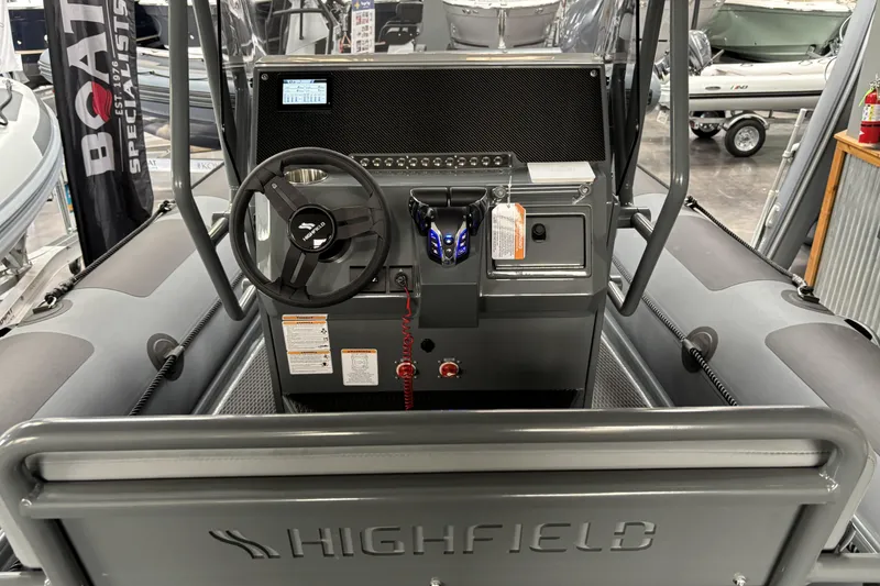 Slide: The Image of Interior view of 2026 Highfield Patrol 760 boat console with steering wheel and controls. - 13