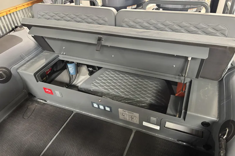 Slide: The Image of Open storage compartment in 2026 Highfield Patrol 760 boat, showcasing interior features and equipment. - 16