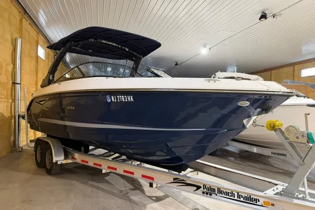 The Image of 2016 Sea Ray SLX 280 boat on trailer in indoor storage facility. - 0