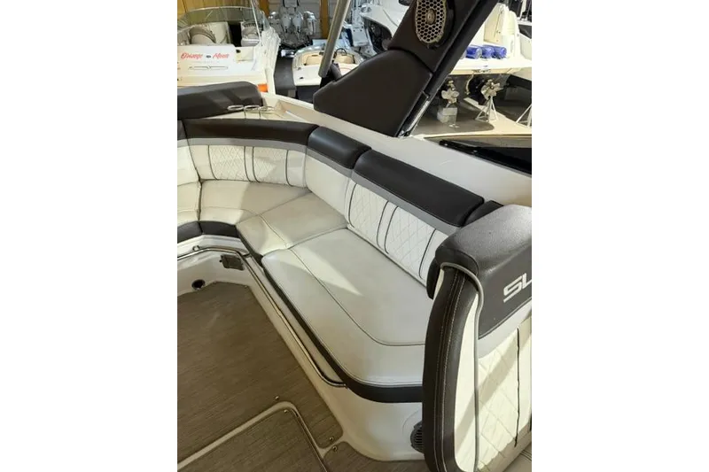 Slide: The Image of Interior seating of 2016 Sea Ray SLX 280 boat, featuring luxurious white and black upholstery. - 11
