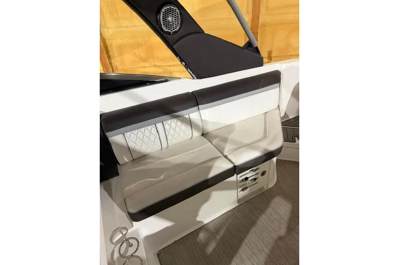 Slide: The Image of 2016 Sea Ray SLX 280 boat interior seating with speaker and cup holders. - 12