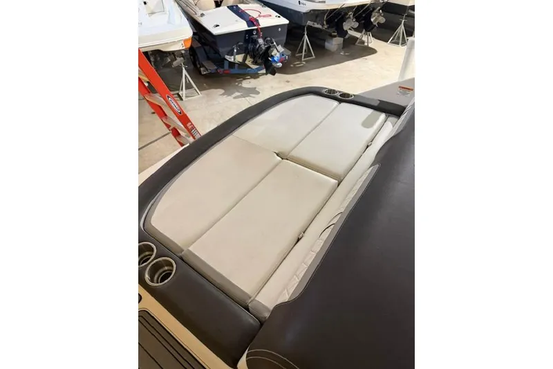 Slide: The Image of 2016 Sea Ray SLX 280 boat interior with cushioned seating and cup holders. - 14