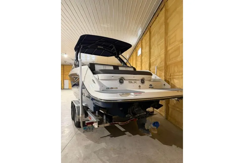 Slide: The Image of 2016 Sea Ray SLX 280 boat in indoor storage on trailer. - 15