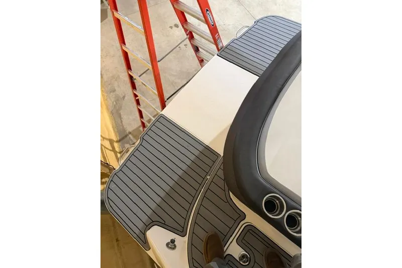Slide: The Image of 2016 Sea Ray SLX 280 boat deck with gray non-slip surface and ladder nearby. - 16