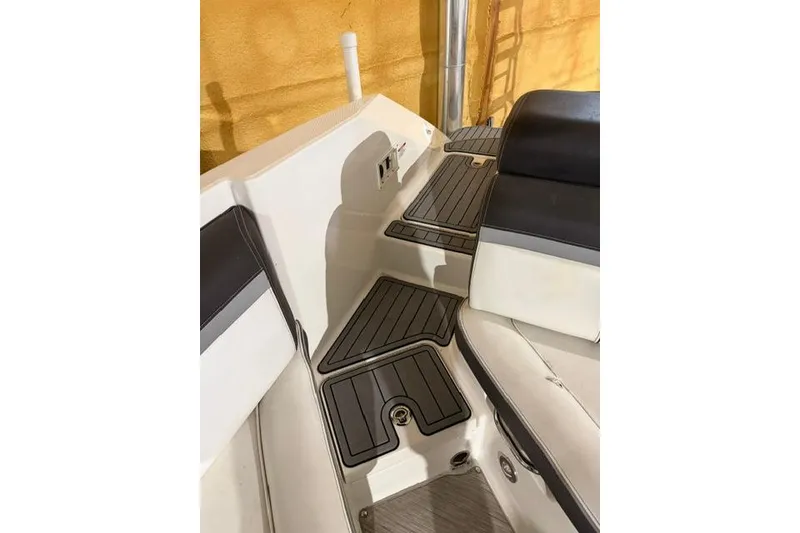 Slide: The Image of Interior view of 2016 Sea Ray SLX 280 boat with cushioned seating and non-slip flooring. - 9