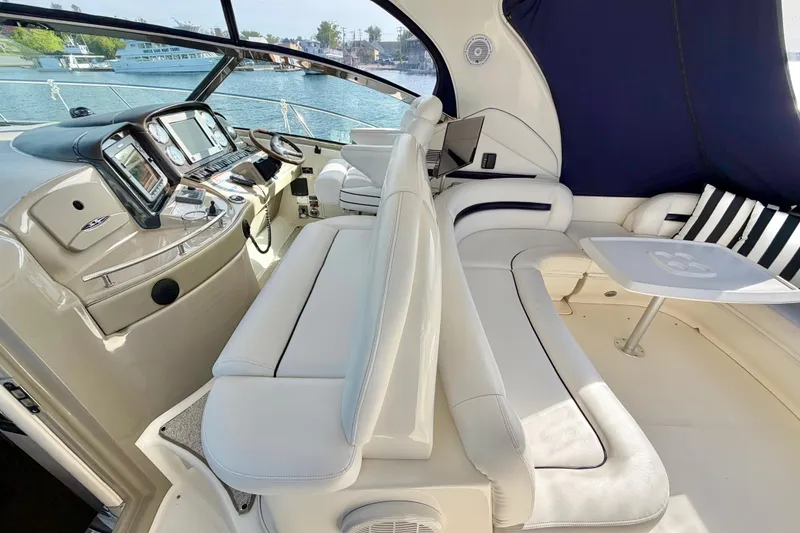 Slide: The Image of 2008 Sea Ray 44 Sundancer yacht interior with plush seating and modern dashboard. - 10