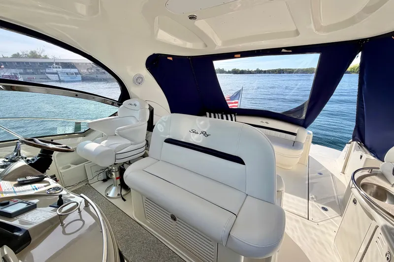 Slide: The Image of 2008 Sea Ray 44 Sundancer yacht interior with plush seating and scenic water view. - 12